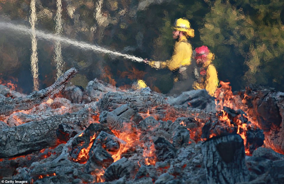 Firefighters battle a blaze at the Salvation Army Camp on Saturday in Malibu, California