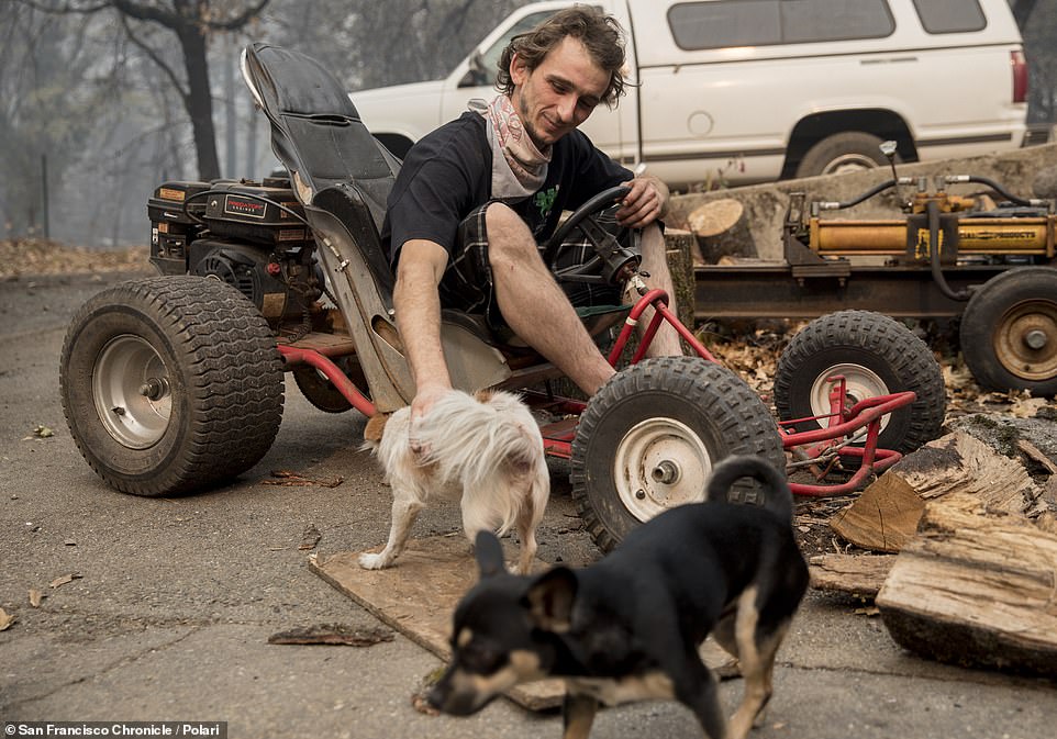 Mic McCrary, 27, sits on a motorized go-cart that he used to rescue his two dogs after the Camp Fire devastated the entire town of Paradise