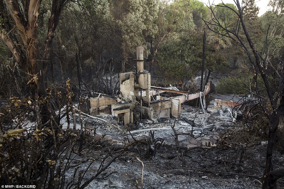 The remains of a house can be seen in Westlake Village, near Thousand Oaks, after the Woolsey Fire swept through Sunday