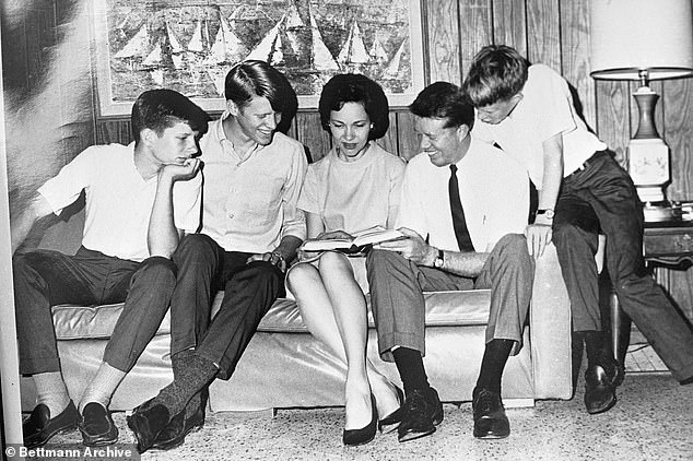 Carter's growing family moved around while he was deployed in the Navy. Above, Carter sits alongside his wife, and three sons in the 1950s, left to right: Chip, Jack, Rosalynn, Carter and Jeff