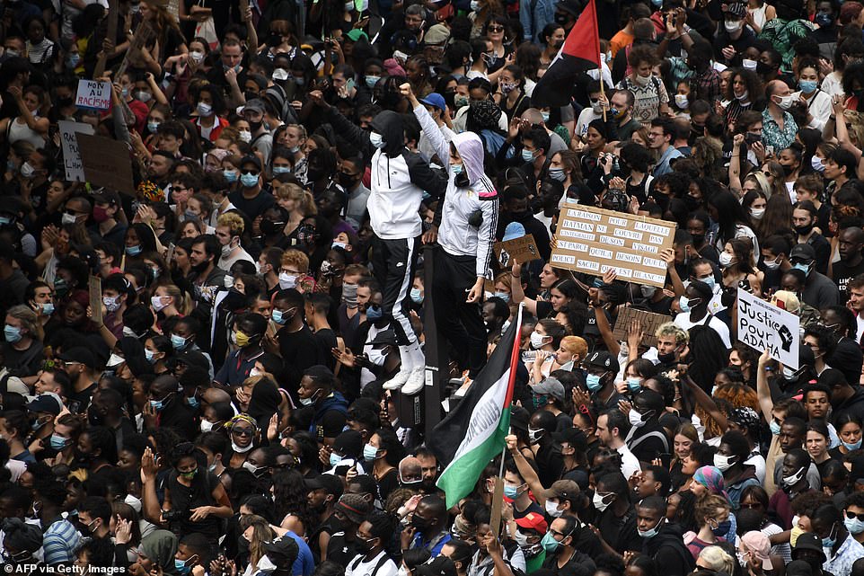 Protesters raise their fists during a rally as part of the 'Black Lives Matter' worldwide protests against racism and police brutality