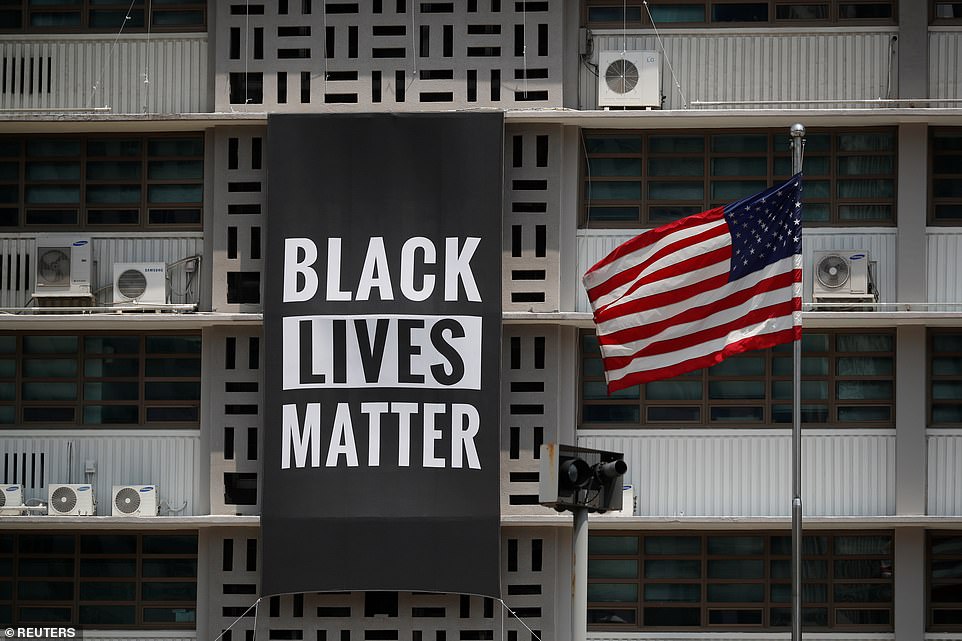 The banner is seen as a rare, open support for the protest by an appointee of President Donald Trump after Trump linked violent protests to 'thugs'