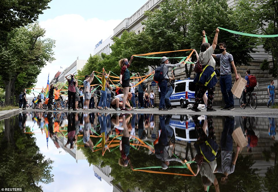 Members of 'Fridays for Future' held onto ribbons as they protested in Berlin in support of the Black Lives Matter movement