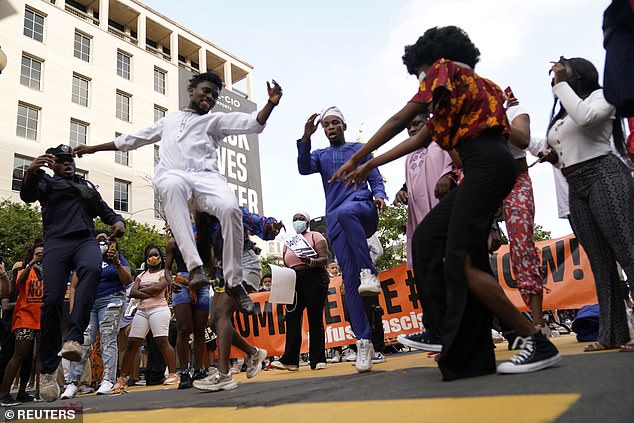 Dancing protesters in Washington DC on Sunday, as Donald Trump marked his 74th birthday