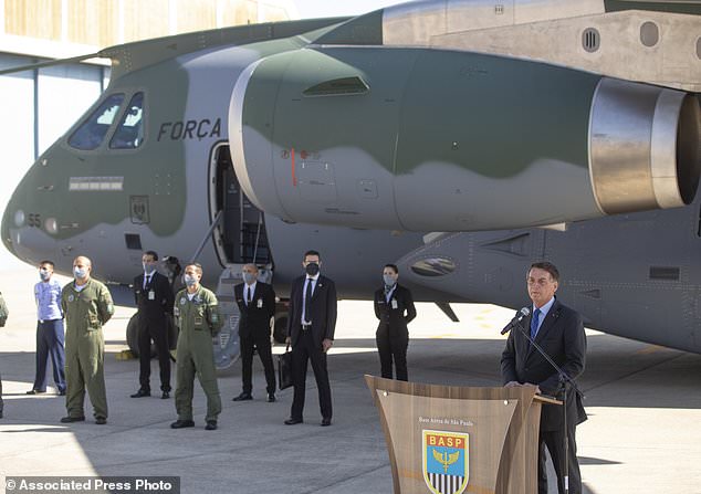 Brazilian President Jair Bolsonaro speaks during a ceremony before a planeload of humanitarian aid takes off for Lebanon, including medical supplies and experts to assist in the wake of the explosion in Beirut, at the Air Force base in Guarulhos, gretar Sao Paulo area, Brazil, Wednesday, Aug. 12, 2020. (AP Photo/Andre Penner)