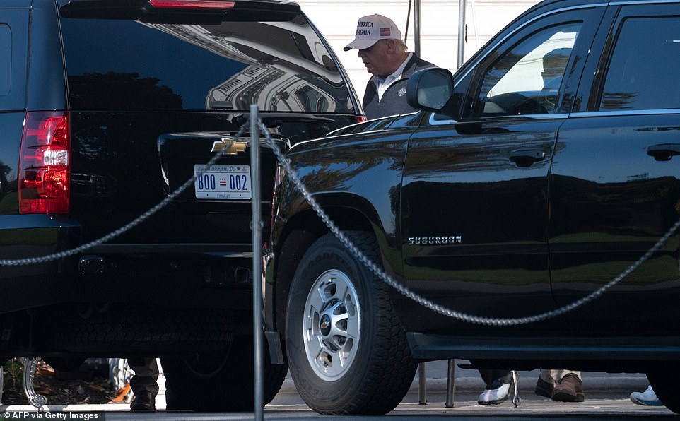 Fore: Trump is seen heading to the golf course on Sunday - perhaps hoping for a better 18 holes than Saturday when he was told he was defeated not long after teeing off