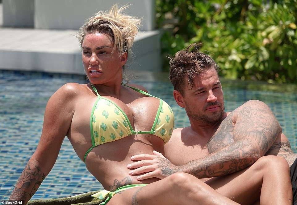 Holiday: Katie Price's fiancé Carl Woods tenderly touched her tummy during their sun-soaked Thailand getaway over the weekend - as her ex Kieran Hayler denied telling their kids she 'is going to prison'