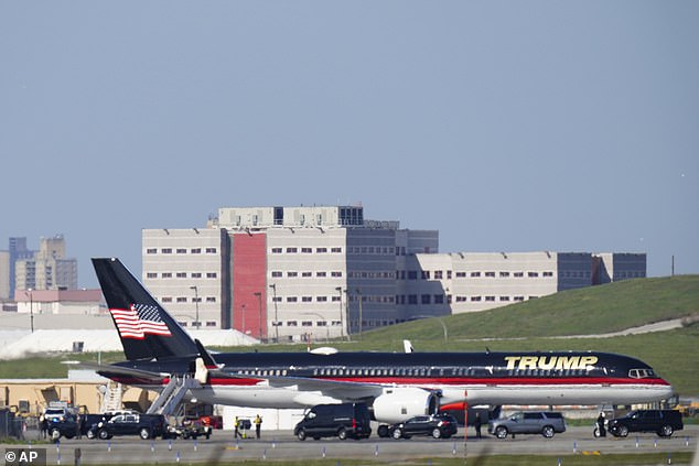 Trump's private plane sits on the tarmac at LaGuardia Airport with the Rikers Island jail in the background