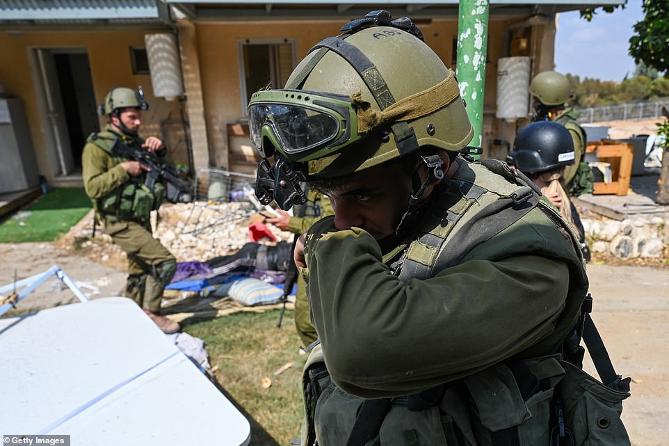 The smell was stomach-turning, reporters said, and Fox News correspondent Trey Yingst took viewers inside one of the bullet-scarred and blood-coated homes. 'You can see the floors are stained with blood,' he said. 'It was Saturday morning, around 7am, when militants stormed this village. You can see the weapons they brought with them, extra ammunition, bullet holes in the side of the house and knives on the floor.'