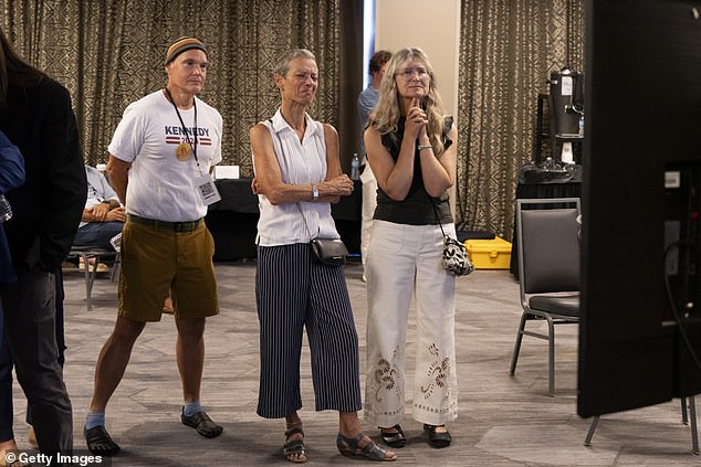 Supporters of Robert F. Kennedy Jr. watch as he suspends his presidential campaign Friday from Phoenix, Arizona - nearby where former President Donald Trump is set to appear