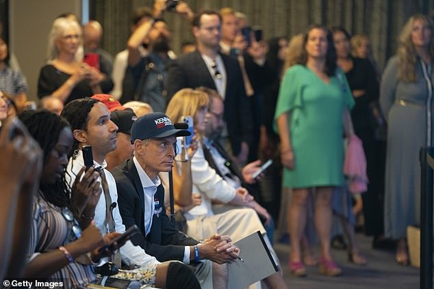 Supporters and reporters watch as independent presidential candidate Robert F. Kennedy Jr. sort of pulled the plug on his campaign. He said he would remove his name from 10 swing state ballots and encouraged supporters there to vote for former President Donald Trump