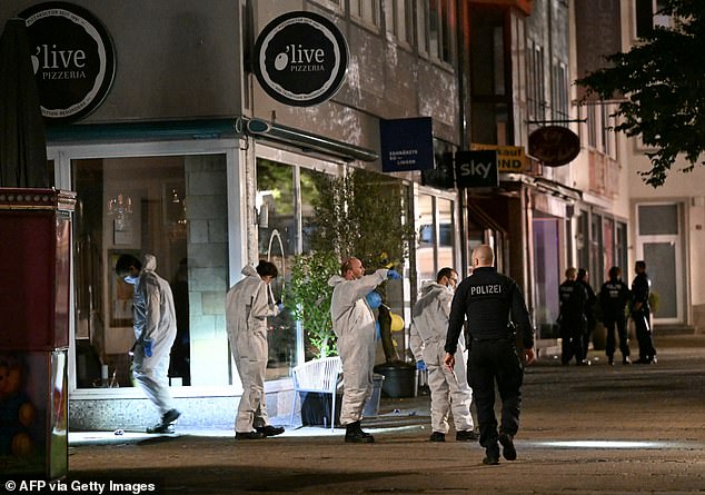 Forensic police inspect on early August 24, 2024 the area where at least three people were killed and several injured when a man attacked them with a knife on late August 23, 2024 in Solingen