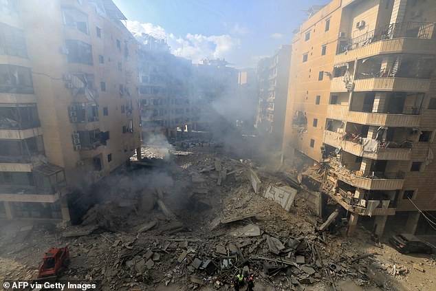 Rescuers check the destruction at the site of an overnight Israeli airstrike in Beirut's southern suburb of Shayyah on October 2