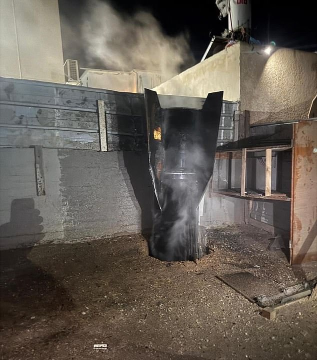 A rocket seemingly embedded in to a building after Iran launched strikes against Israel