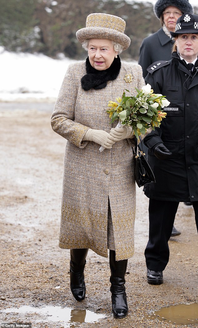 Queen Elizabeth II carries a bouquet of flowers as she leaves the church of St Peter and St Paul in West Newton after attending Sunday Service on February 5, 2012