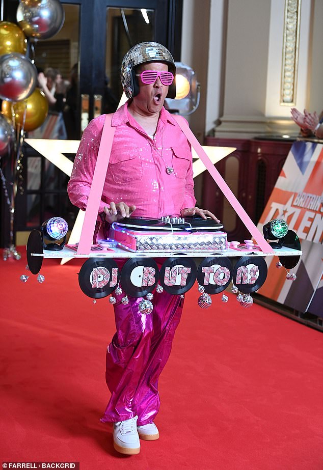 While a DJ walked the red carpet wearing a set of decks around his neck and sporting bright pink metallic trousers, a matching sequin shirt and a disco ball helmet