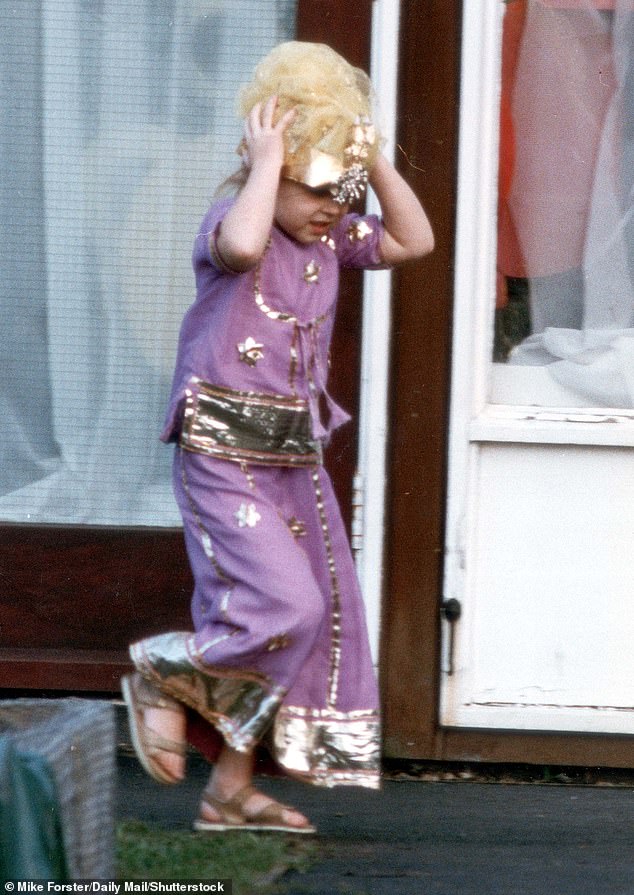 Four-year-old Beatrice holding on to her crown and wearing her costume thought to have been made by her mother, Sarah