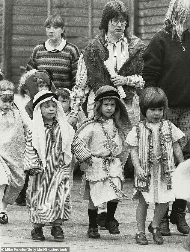 Four-year-old Prince Harry walking with his classmates while dressed as a shepherd for his school play in 1988