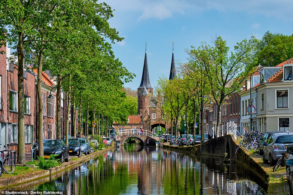 Pictured is Delft, a city in the Netherlands, located between Rotterdam and The Hague. It is 'known for its charming canals and historical facades', says Visit Holland. The tourism board adds that 'it is a living museum of Dutch history and culture'