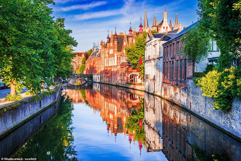 Pictured is Bruges, in northwest Belgium, a city that has 'magnificent' canal views around every bend, says Visit Bruges. The tourism team explains that 'the canals have for centuries been the veins of the city', recommending tourists 'take a stroll or a boat trip and discover secret gardens, romantic bridges and medieval facades reflected in the water'