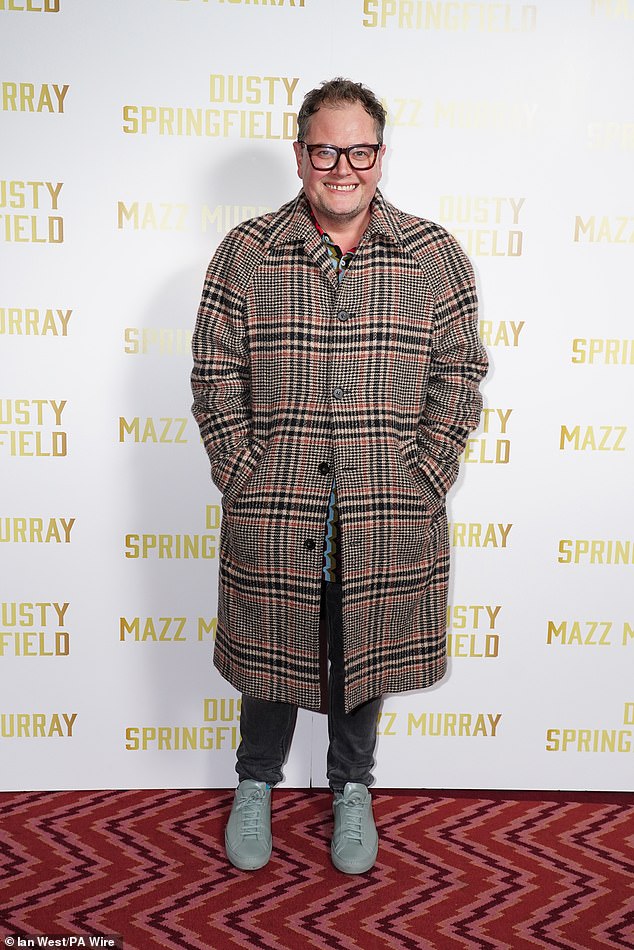 Meanwhile, comedian Alan Carr donned a red and black checked coat as he beamed for snaps