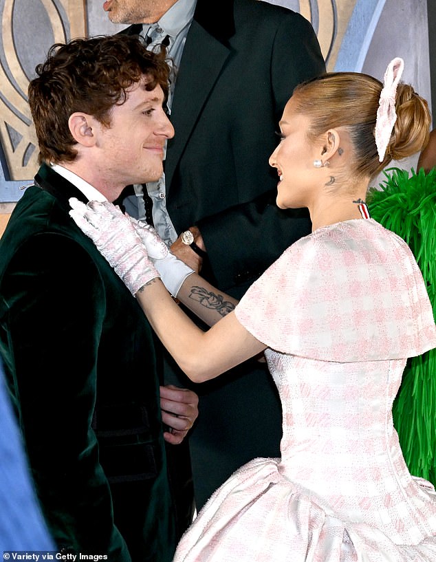 Look of love: Ariana and Ethan at the Wicked Los Angeles premiere, where the singer fussed over her boyfriend on the red carpet