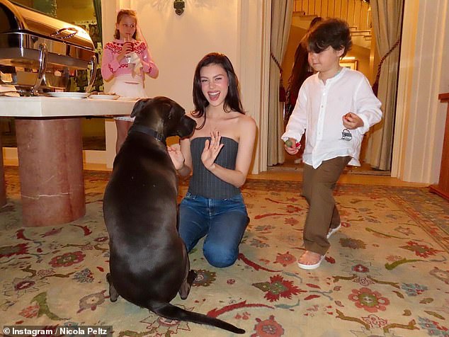 Nicola seemed to be in great spirits as she played with the family dog