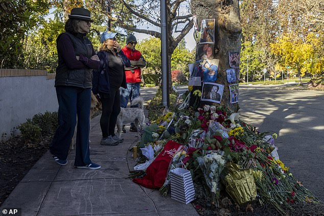 People visit a memorial displayed for victims of a Tesla Cybertruck crash in Piedmont