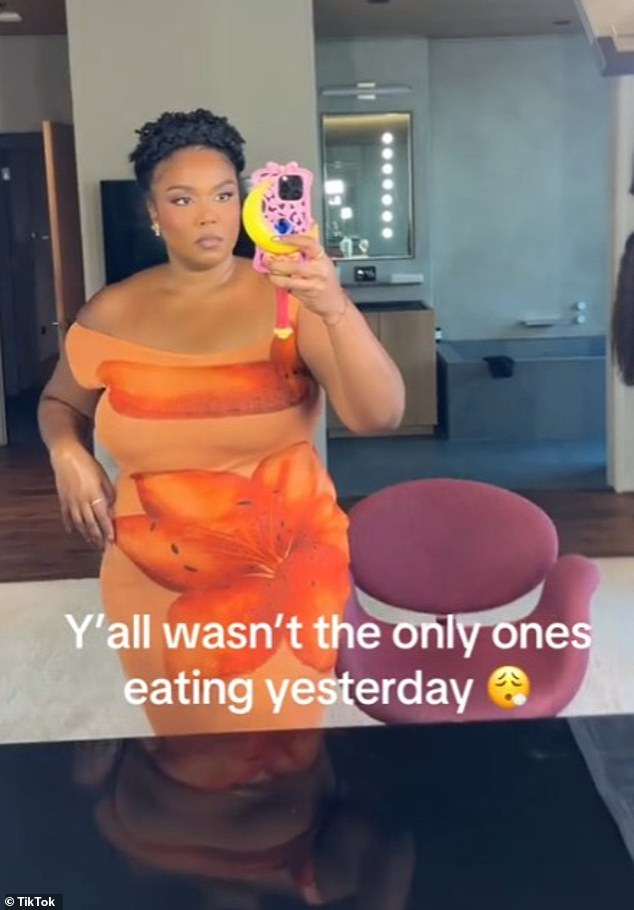 In the clip she posted on Friday, she gave her fans a peek at her look, showcasing her slimmed-down figure in a skintight, off-the-shoulder dress with orange hibiscus flowers