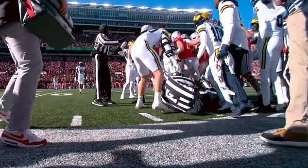 A referee was nearly badly hurt after getting caught in a brawl between Ohio State and Michigan