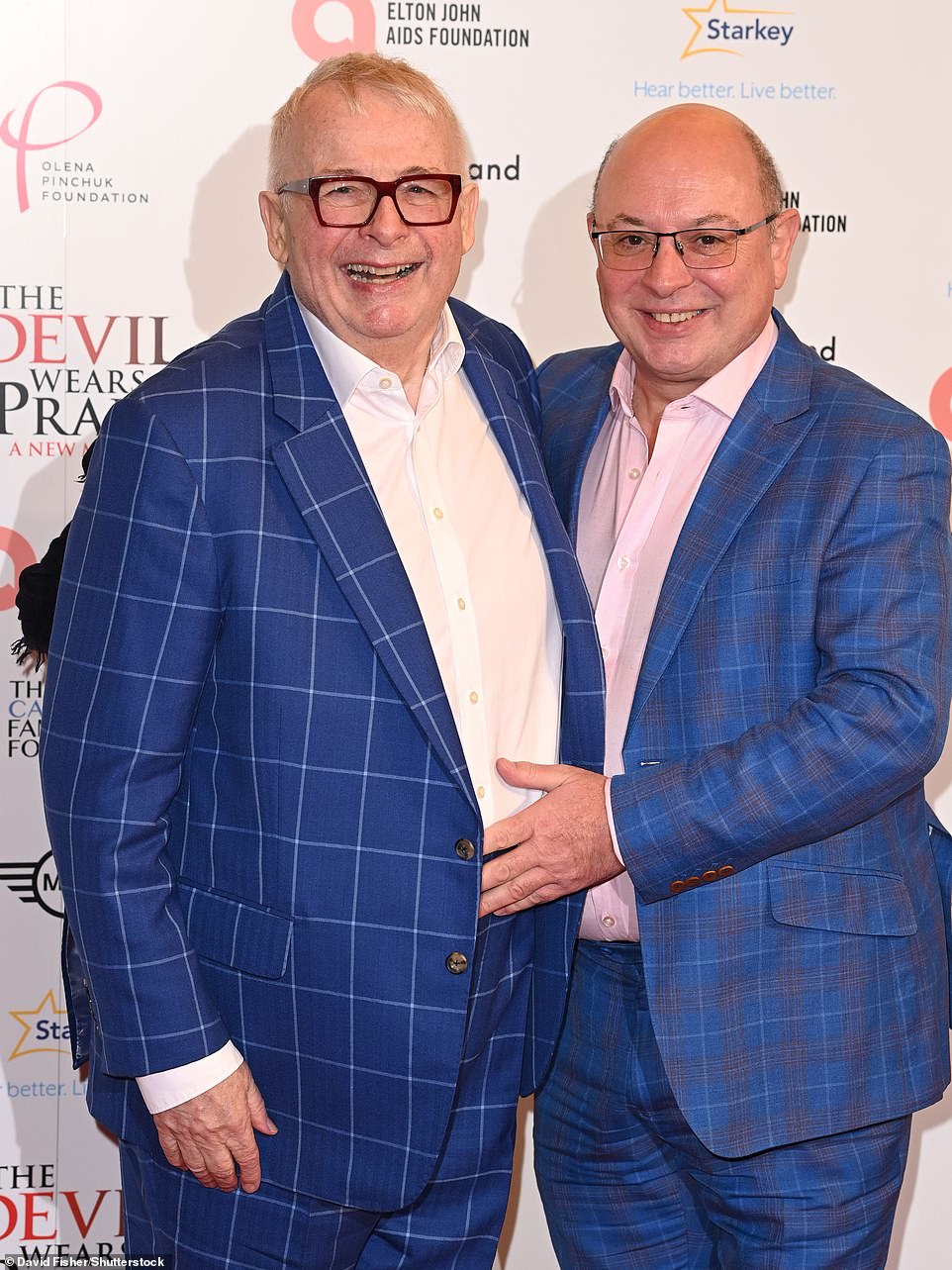 Christopher Biggins, 75, was in great spirits as he posed on the red carpet alongside husband Neil Sinclair (R)