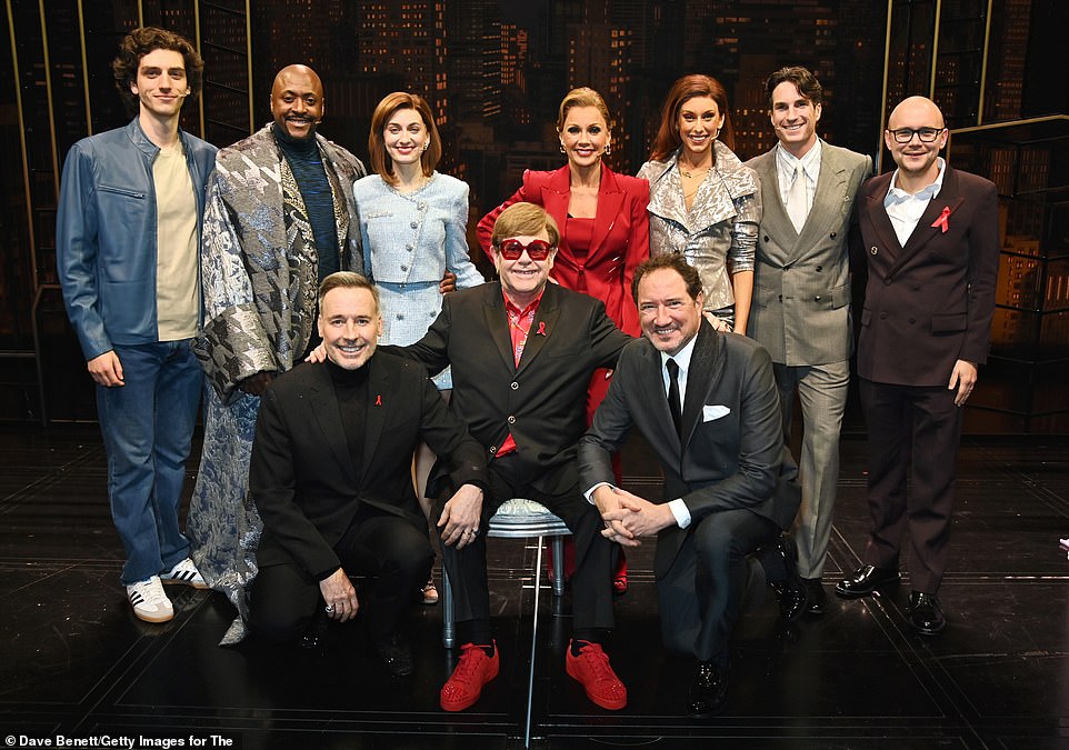 Sir Elton (centre) later posed with the cast following the show