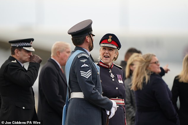 Royal Air Force personnel and police wait for the Emir of Qatar to arrive at Stansted today