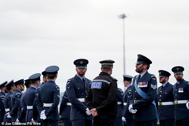 Royal Air Force personnel and police wait for the Emir of Qatar to arrive at Stansted today