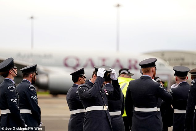 Royal Air Force personnel and police wait for the Emir of Qatar to arrive at Stansted today