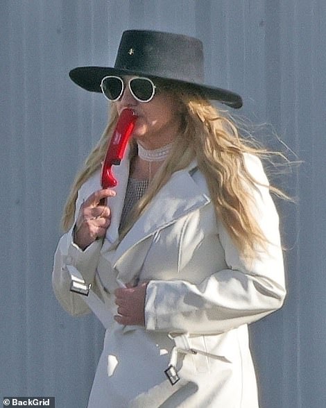 Spears placed the lighter against her mouth and chin during the day