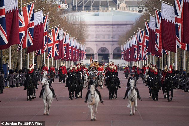 King Charles III travels in the Irish State Coach with the Emir of Qatar Sheikh Tamim bin Hamad Al Thani and his wife Sheikha Jawaher along The Mall to Buckingham Palace today