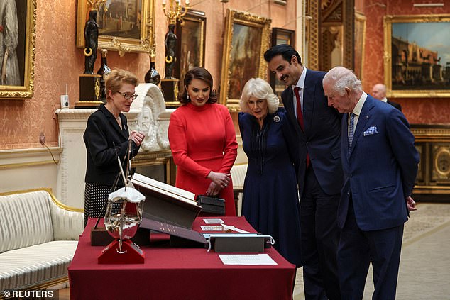 King Charles and Camilla view a display of Qatari items at Buckingham Palace today