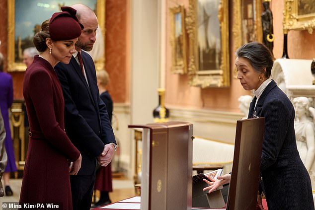 The Prince and Princess of Wales view Qatari items at Buckingham Palace today