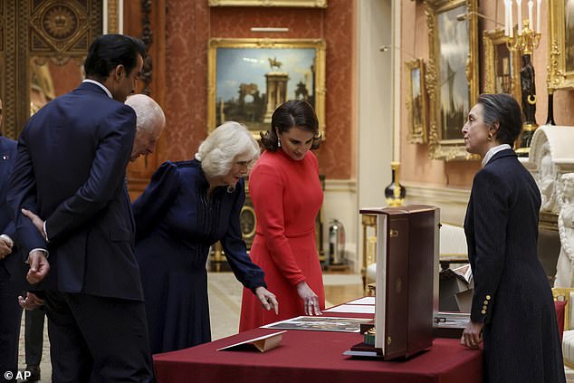 Sheikha Jawaher bint Hamad bin Suhaim Al-Thani and Camilla view items at Buckingham Palace