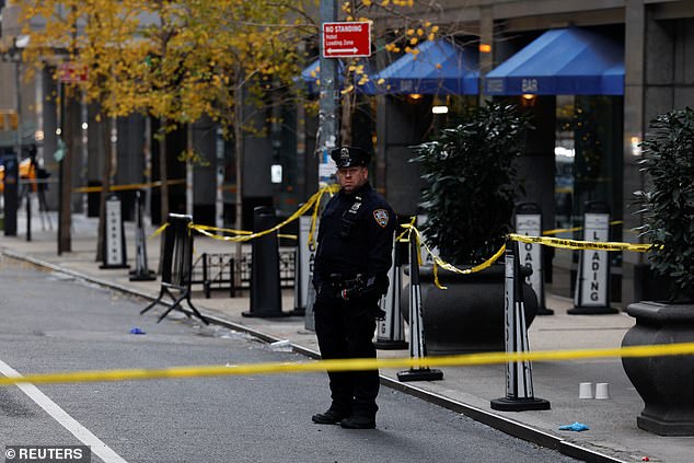 NYPD officers at the scene of the shooting near W. 54th St. and 6th Avenue. A witness said the shooter killed Thompson from point blank range before fleeing on a bicycle