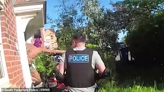 Shocking footage shows a crack and heroin dealer trying to escape police as they cut through his front door with a chainsaw