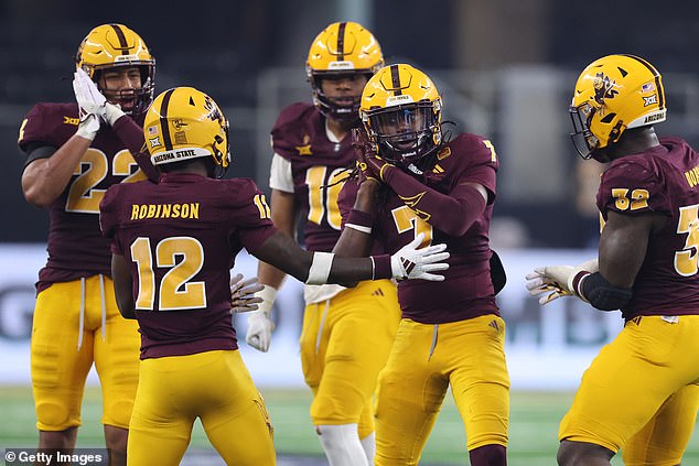 Simmons celebrated the sack by gesturing that he had sent Becht to sleep (second right)