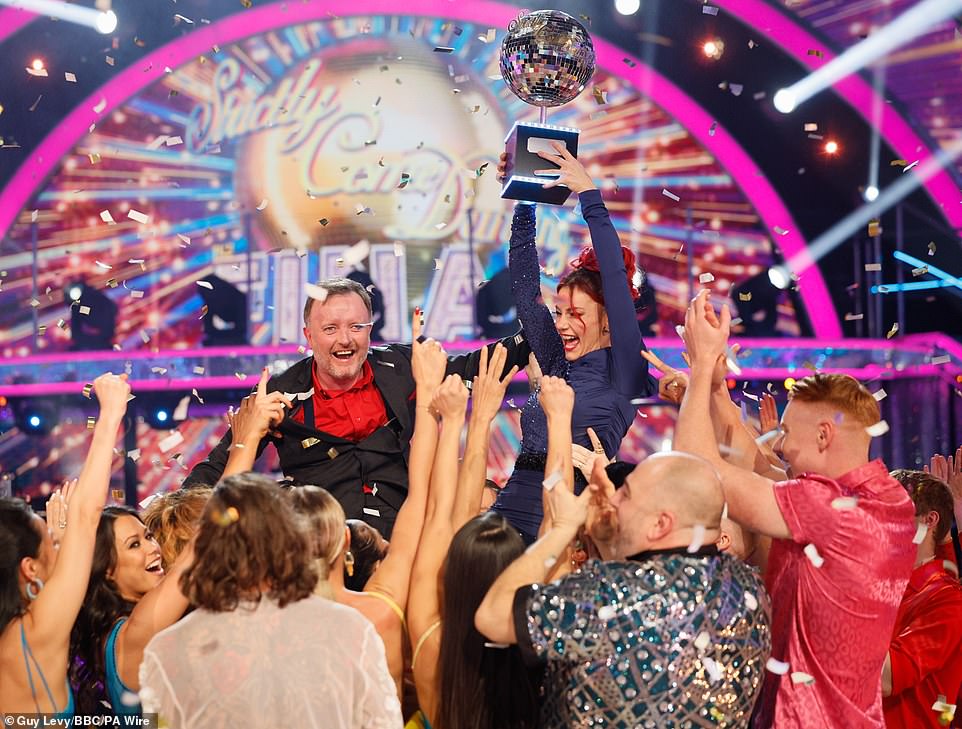 Chris and Dianne couldn't contain their excitement as they triumphantly raised the Glitterball trophy