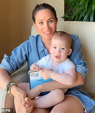 In the early years after their childrens' births, the Duke and Duchess of Sussex appeared happy to release photos of their faces - but this year's Christmas card may mark a sea change for them when it cokes to Archie and Lilibet's privacy (Pictured: Meghan and Archie on his 1st birthday)