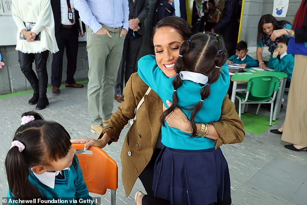 Prince Harry and Meghan Markle are putting their 'children's privacy' first but 'tenderest PDAs' are reminder of 'their tactile, empathetic behaviours', a body language expert claimed. Meghan Markle pictured during Colombia trip earlier this year