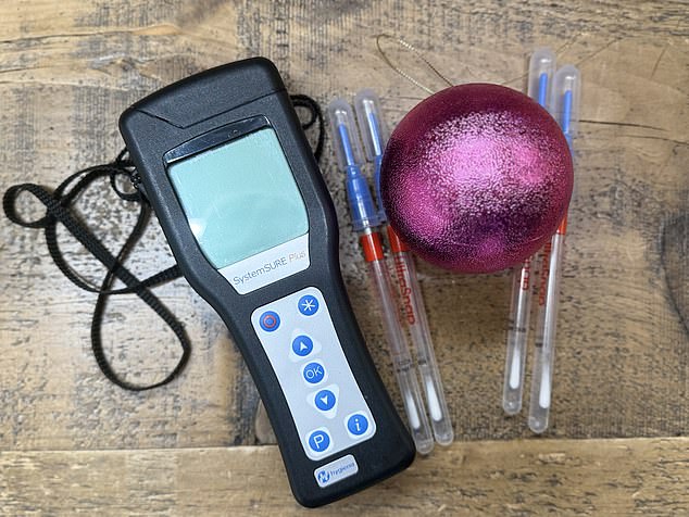 Of all the items swabbed, artificial Christmas tree boxes were the worst on average, with readings of around 845 units. Pictured: A testing kit with a festive bauble