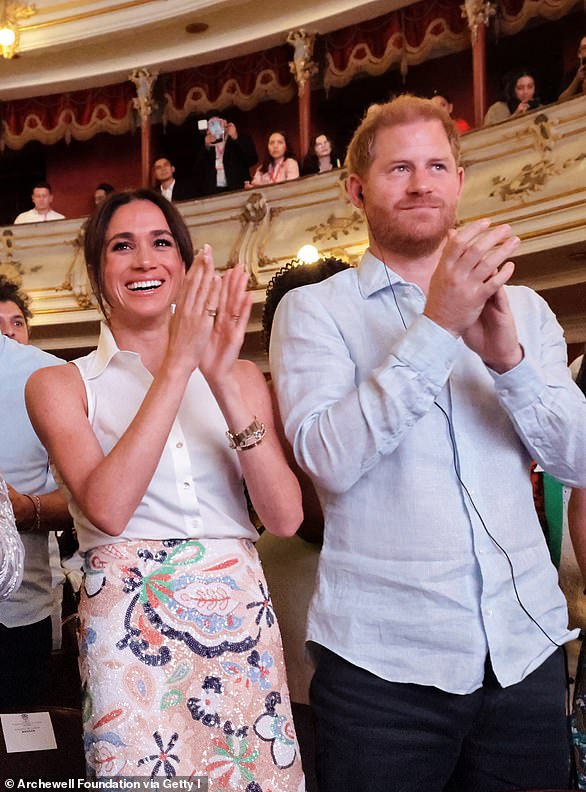 Meghan looked radiant in a patterned pencil skirt embellished with sequins, which she paired with a sharp white shirt and pink, suede pumps