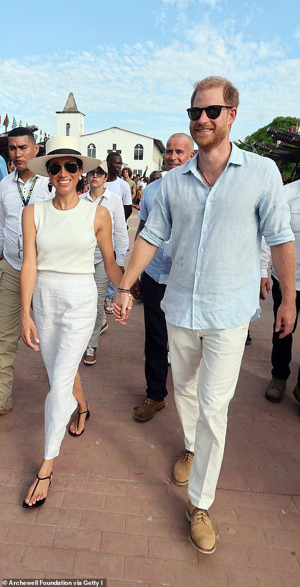 Meghan Markle and Prince Harry looked loved up as they held hands while visiting traditional Afro-Caribbean village, San Basilio de Palenque on Saturday