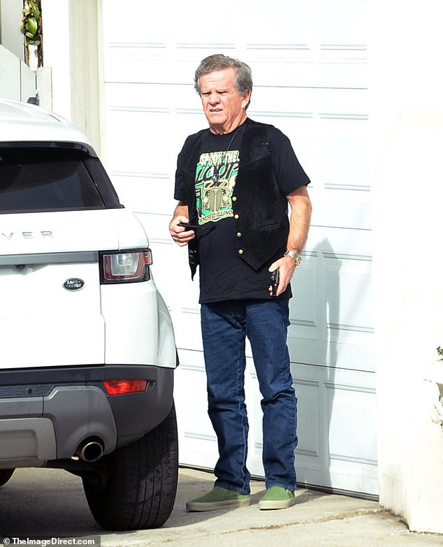 Patrick sported a classic pair of Ray-Bans, a dark pair of jeans, a black leather vest to complete the outfit and what appears to be a pair of green Slip-On Vans